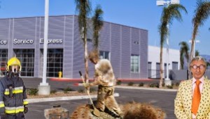 Larry Dick Zindle (center) climbs out of hole. Dealership owner Futz Delahee is shown at right