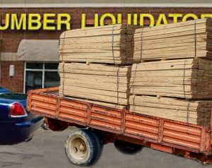 A Rolls-Royce Dawn pulling a trailer filled with wood leaves Lumber Liquidators