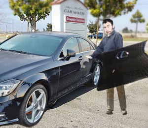 Car wash employee Toby Buzzello carries around this Lexus grille while working. His index finger (shown middle left) became stuck when he tried to towel dry a mesh hole