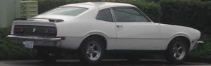 Blackout rear panel and wing, and Kilz-primer painted steel wheels identify this Aston-Martin Vantage as an S model. 