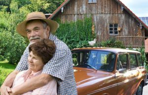 Howdy Mussel gropes his wife Canola in front of their 1973 VW Squareback, which burned last year. Putz, their pet game hen, is posing atop the car. He's dead, too. 