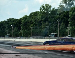 Sparks fly as the Roomba Rambo tears down the track ahead of the Model S P100D