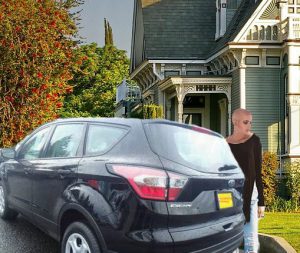 Kitten Pubguffer stands next to her new Ford Escape